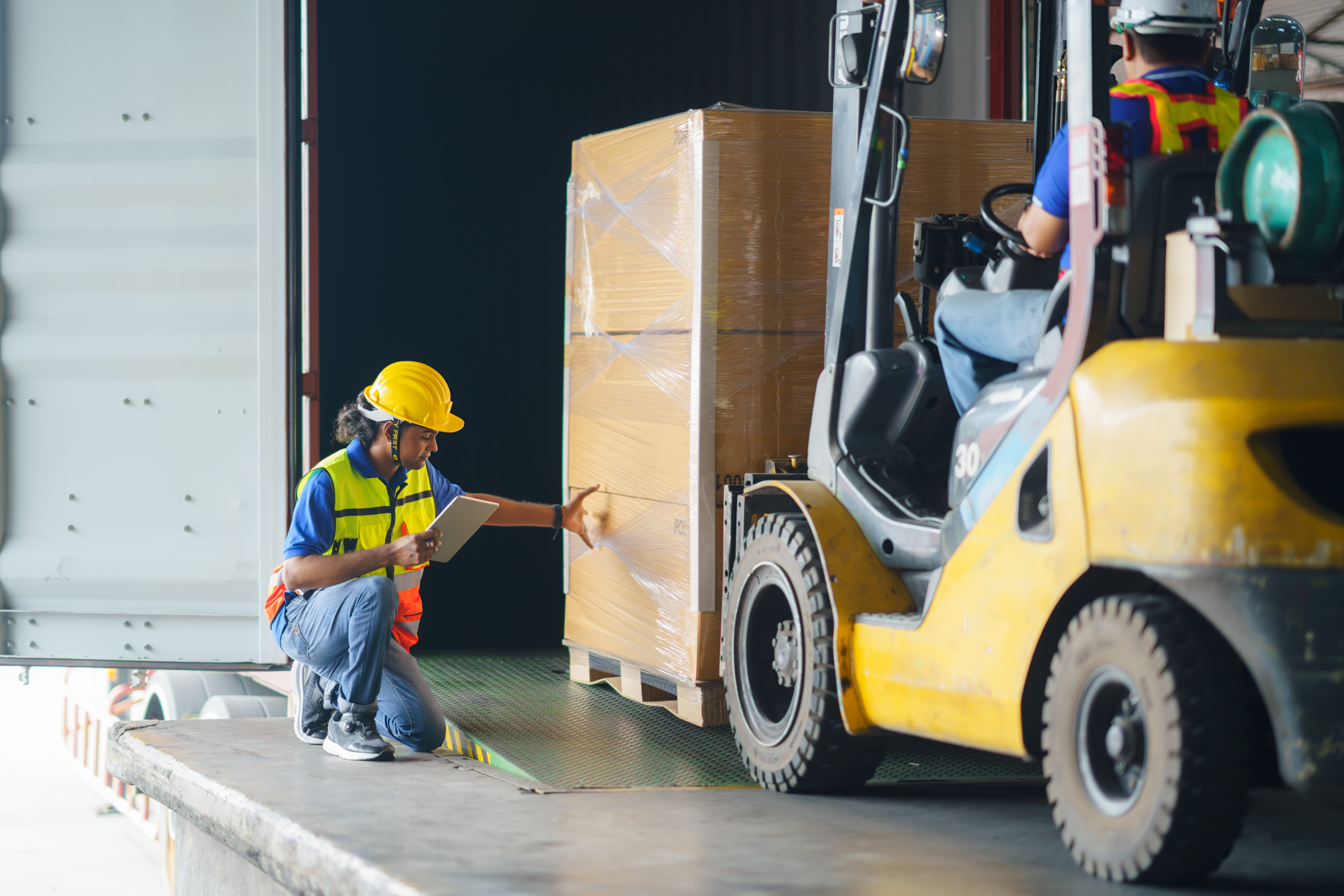 Asian Forklift Driver Loading a Shipping Cargo Container with a (1)